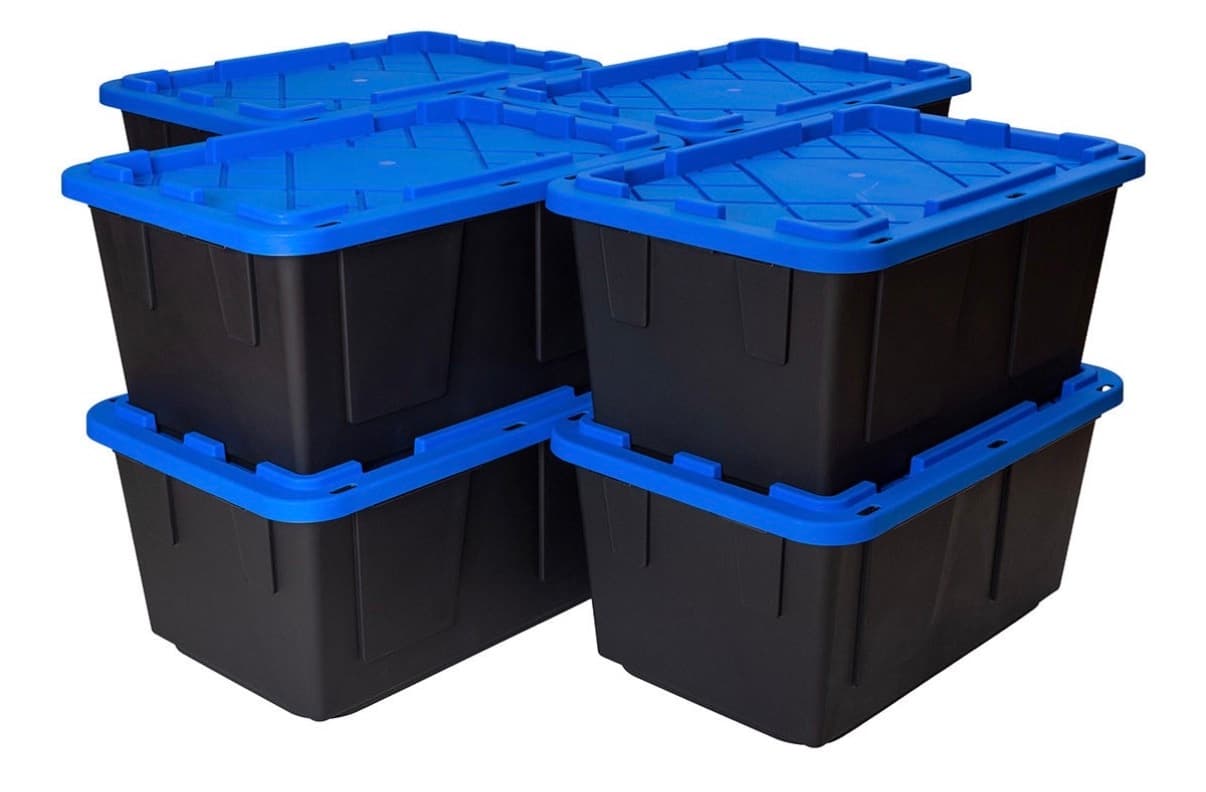 Four black moving totes with royal blue lids stacked two high and two wide